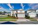 Two-story home showcasing manicured landscaping and a convenient two-car garage at 2313 Ivy Harvest Pl, Oviedo, FL 32765