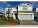Charming two-story home with a well-maintained lawn, brick driveway, and an attached two-car garage at 2313 Ivy Harvest Pl, Oviedo, FL 32765