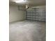 Empty garage with a smooth concrete floor and a sectional garage door at 2313 Ivy Harvest Pl, Oviedo, FL 32765