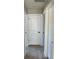 Hallway featuring three white doors and neutral carpet at 2313 Ivy Harvest Pl, Oviedo, FL 32765