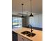 Kitchen island with stainless steel sink and a view of the outdoor living space at 2313 Ivy Harvest Pl, Oviedo, FL 32765