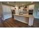 Modern kitchen features white cabinets, stainless appliances, and spacious island at 2313 Ivy Harvest Pl, Oviedo, FL 32765