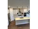 Bright, modern kitchen with large island, stainless steel appliances and pendant lights at 2313 Ivy Harvest Pl, Oviedo, FL 32765