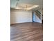 Spacious living room with wood floors, decorative wall paneling and stylish modern chandelier at 2313 Ivy Harvest Pl, Oviedo, FL 32765