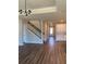 Open concept living area featuring hard wood flooring, staircase and white kitchen cabinets at 2313 Ivy Harvest Pl, Oviedo, FL 32765