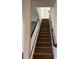 A wooden staircase with a white railing leads to the upper level at 2313 Ivy Harvest Pl, Oviedo, FL 32765