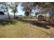 Large backyard features an enclosed fence, storage shed, and mature trees providing shade at 2360 Justy Way, Orlando, FL 32817