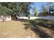 Expansive backyard with mature trees and a privacy fence, perfect for outdoor enjoyment at 2360 Justy Way, Orlando, FL 32817