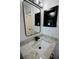 Bathroom vanity with marble countertop and a framed mirror at 2360 Justy Way, Orlando, FL 32817