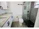 Modern bathroom featuring black fixtures, a glass shower door, and a marble vanity at 2360 Justy Way, Orlando, FL 32817