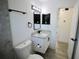 Modern bathroom with a granite countertop vanity, black fixtures, and a decorative shelving unit at 2360 Justy Way, Orlando, FL 32817