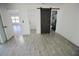 Bedroom featuring a barn door leading to the bathroom and wood-look tile flooring at 2360 Justy Way, Orlando, FL 32817