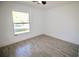 Bright bedroom with stylish gray wood-look tile flooring and a large window for natural light at 2360 Justy Way, Orlando, FL 32817