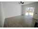 Bedroom with a sliding glass door leading to backyard, ceiling fan, and wood-look flooring at 2360 Justy Way, Orlando, FL 32817