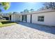 Beautiful home featuring a gray brick driveway and a freshly painted white exterior with black accents at 2360 Justy Way, Orlando, FL 32817