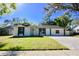 Charming one story home featuring a well-manicured lawn and a paved driveway at 2360 Justy Way, Orlando, FL 32817
