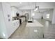 Spacious kitchen features an island with marble countertop, stainless appliances, and pendant lighting at 2360 Justy Way, Orlando, FL 32817