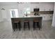 Open kitchen with island, pendant lights, white cabinets, and stainless steel appliances at 2360 Justy Way, Orlando, FL 32817