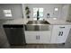 Kitchen island featuring a stainless steel sink, dishwasher, and white cabinets at 2360 Justy Way, Orlando, FL 32817