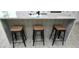 Kitchen island with seating for three features a white countertop and decorative wood paneling at 2360 Justy Way, Orlando, FL 32817