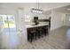 Open concept kitchen with a center island, modern lighting, white cabinets, and stainless steel appliances at 2360 Justy Way, Orlando, FL 32817