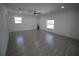 Bright, expansive living room featuring modern wood-look tile floors and abundant natural light at 2360 Justy Way, Orlando, FL 32817