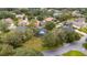 Overhead shot of a charming home nestled among mature trees, showcasing its well-kept lawn and neighborhood at 2365 Eagle Trace Dr, Kissimmee, FL 34746