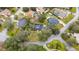 An aerial perspective showcases a residential neighborhood with mature trees lining the streets and yards at 2365 Eagle Trace Dr, Kissimmee, FL 34746