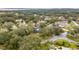 An aerial view of a cozy neighborhood with mature trees and lush greenery, featuring a charming home at 2365 Eagle Trace Dr, Kissimmee, FL 34746