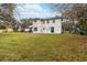 Expansive backyard showcases a well-maintained lawn, the home's exterior, and a charming playset at 2365 Eagle Trace Dr, Kissimmee, FL 34746
