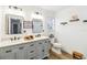 Bright bathroom with double sink vanity, modern fixtures, and wood-look floors at 2365 Eagle Trace Dr, Kissimmee, FL 34746