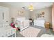 Bright Bedroom with white crib, dresser, decor, and cozy rug, creating a warm and inviting space at 2365 Eagle Trace Dr, Kissimmee, FL 34746