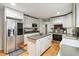 Well-lit kitchen showcasing white cabinetry, a stainless steel refrigerator, and a functional center island at 2365 Eagle Trace Dr, Kissimmee, FL 34746