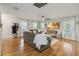 Bright living room with hardwood floors, a comfortable sofa, and sunlit windows with white curtains at 2365 Eagle Trace Dr, Kissimmee, FL 34746