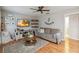 Comfortable living room with a ceiling fan, entertainment center, decorative shelves, and a cozy couch and coffee table at 2365 Eagle Trace Dr, Kissimmee, FL 34746
