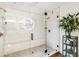 Modern shower with glass door, white tile, and built-in bench at 2365 Eagle Trace Dr, Kissimmee, FL 34746