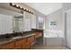 Spacious bathroom features a large vanity, soaking tub, and a separate shower stall at 248 Rosso Dr, Davenport, FL 33837