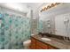 Bright bathroom with granite countertop, a single sink vanity and leaf-themed shower curtain at 248 Rosso Dr, Davenport, FL 33837