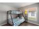 Well-lit bedroom with bunk beds, wood-look flooring, and modern decor at 248 Rosso Dr, Davenport, FL 33837