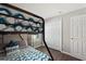 Cozy bedroom with bunk bed, wood floors, closet, and natural light at 248 Rosso Dr, Davenport, FL 33837