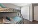 Charming bedroom features a bunk bed, wood floors, and bright natural light from the window at 248 Rosso Dr, Davenport, FL 33837