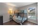 Bedroom featuring bunk beds, wood flooring, and a window offering views of screened pool area at 248 Rosso Dr, Davenport, FL 33837