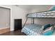 bedroom with bunk bed, dark wood floors and bright blue decor accents at 248 Rosso Dr, Davenport, FL 33837