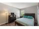 Bedroom with wood floors, large window, and dark wood furniture at 248 Rosso Dr, Davenport, FL 33837