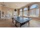 Bright game room with ping pong table, tables, and chairs, perfect for fun and relaxation at 248 Rosso Dr, Davenport, FL 33837