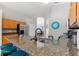 Kitchen featuring a breakfast bar, stainless refrigerator, and views to game room at 248 Rosso Dr, Davenport, FL 33837