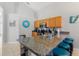 Kitchen featuring a granite breakfast bar with seating at 248 Rosso Dr, Davenport, FL 33837