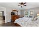 Main bedroom offers wooden furnishings, fan, generous window views, and access to ensuite bathroom at 248 Rosso Dr, Davenport, FL 33837