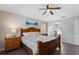 Main bedroom showing bedside tables, wood trim bed, ocean art and access to ensuite bathroom at 248 Rosso Dr, Davenport, FL 33837