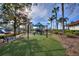 Community playground with swings, slides, and artificial turf for the residents in a lush landscaped yard at 248 Rosso Dr, Davenport, FL 33837